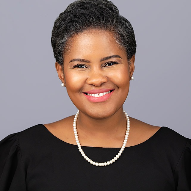 Friendly corporate headshot of a young Black female entrepreneur in smart casual attire